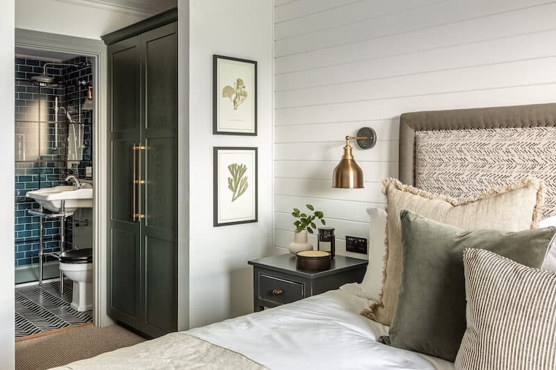 Shiplap wall treatment paired with modern lighting in an elegant basement design