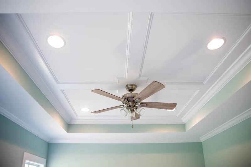 Sophisticated tray ceiling with wood accents in an upscale basement remodel